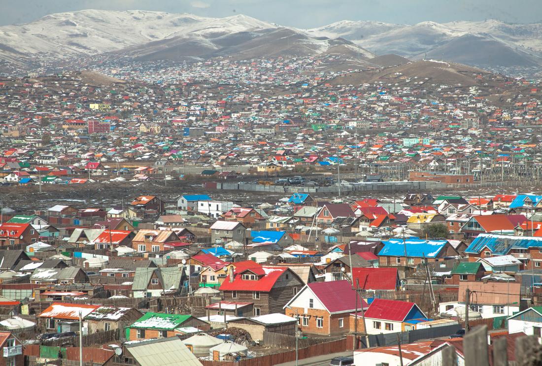 Colorful houses in front of mountain range in Mongolia