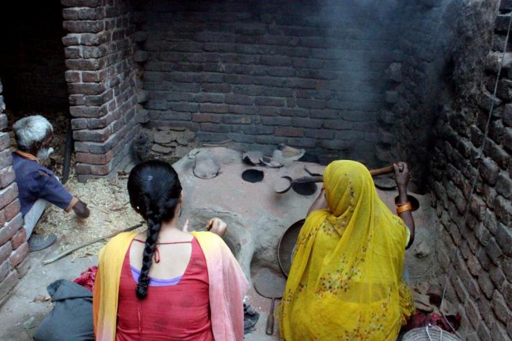 Women using a cookstove in India. Photo: Thomas Chupein | J-PAL/IPA