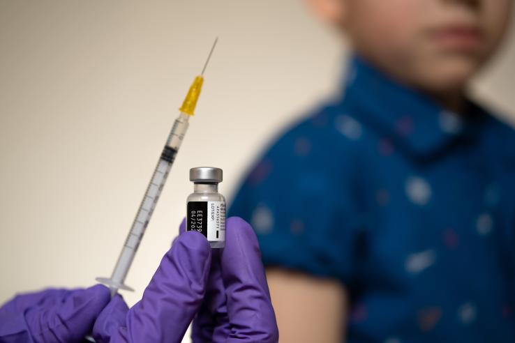 A vaccine injection is being prepared for a child.