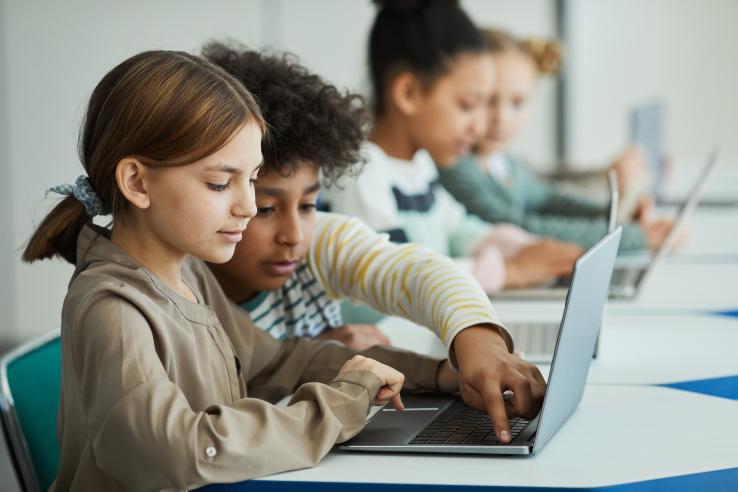 Children sitting in front of computers