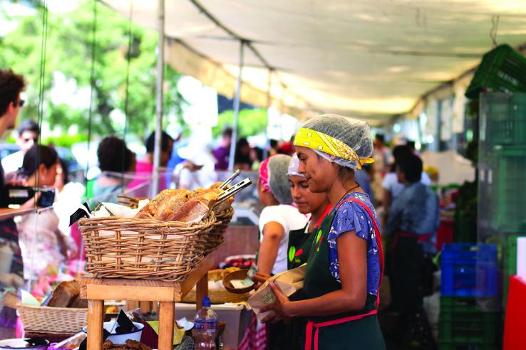 Woman selling bread at a market. Myriam B | Shutterstock