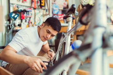 Young man repairing a bike