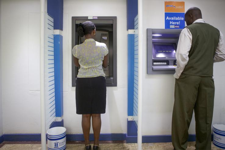 Man and woman using an ATM machine